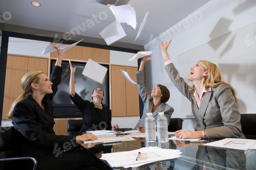 Preview: Group Of Businesswomen Throwing Papers At Meeting