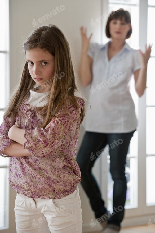 Preview: Portrait Of Sulking Daughter With Mother In Background