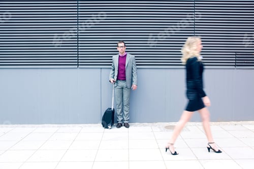 Preview: Young Businessman Looking At Businesswoman Walking By, Blurred Motion