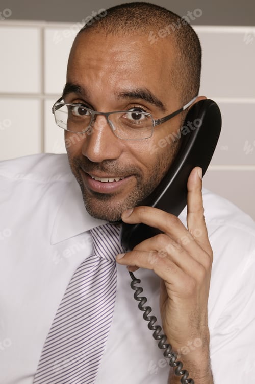 Preview: View Of A Businessman On The Phone Smiling For The Camera