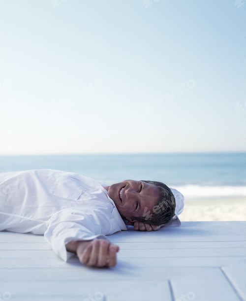 Preview: Portrait Of A Young Man Lying On A Deck Beside The Beach
