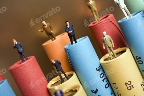 Preview: Rolls Of Assorted Euro Coins With Businessmen Figurines