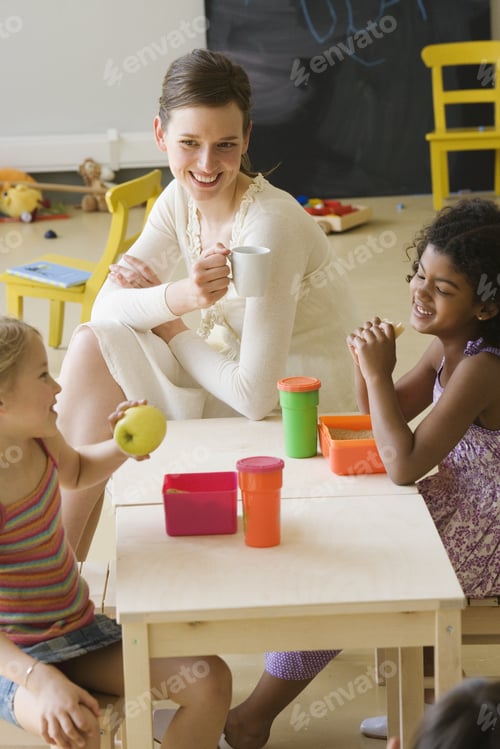 Preview: Happy Children and Teacher Enjoying Snack Time