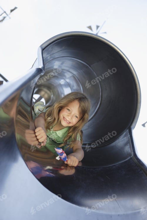 Preview: Girl Sliding Head First Down Slide With Pinwheel