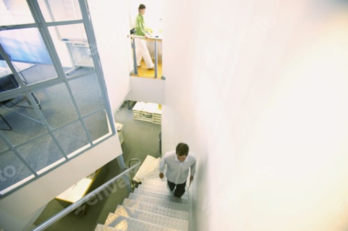 Aperçu: High Angle View Of A Young Man Climbing A Staircase