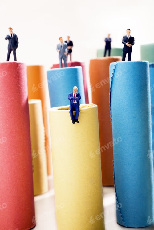 Preview: Rolls Of Assorted Euro Coins With Businessmen Figurines