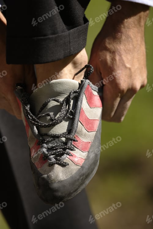 Preview: Man Putting On Rock Climbing Shoe