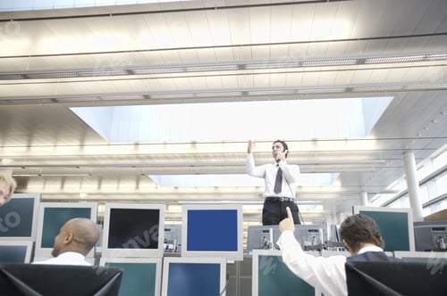 Preview: Businessman Standing On Desk Using Telephone