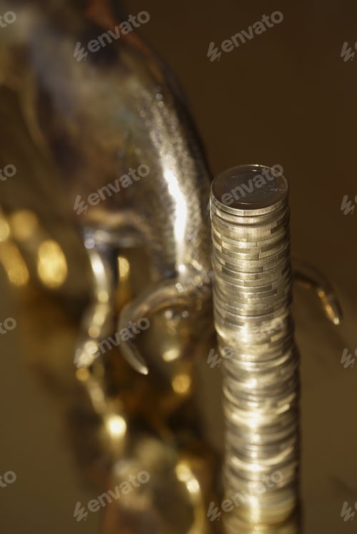 Preview: Stack Of One Euro Coins Next To Bull Figurine