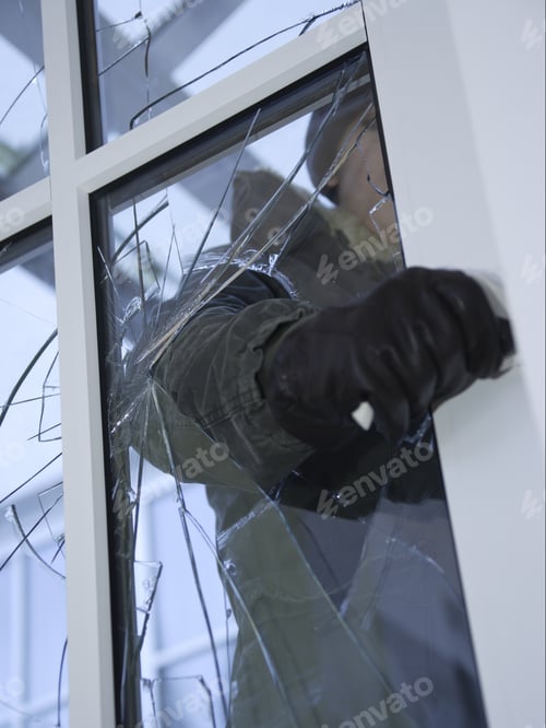Preview: Burglar Reaching Through Broken Glass On Door