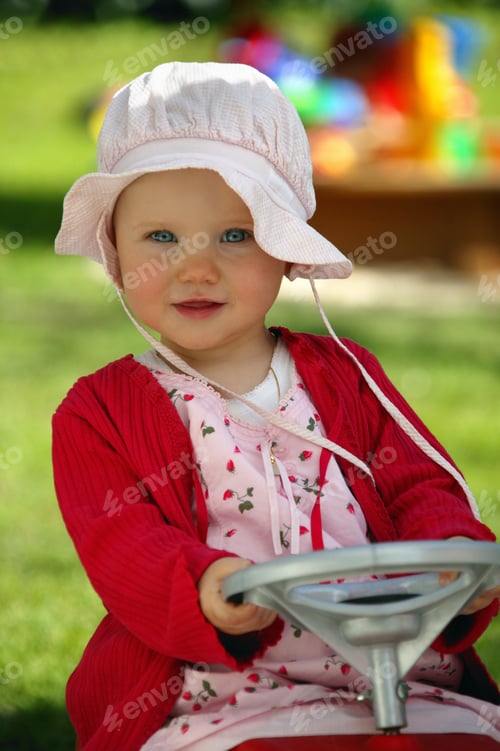 Preview: View Of A Baby Girl Driving A Toy Car