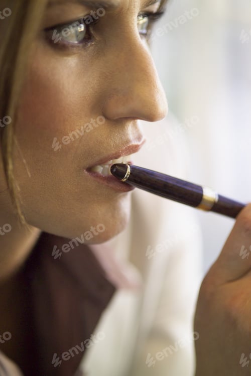 Preview: Close Up Of Businesswoman With Pen On Lip