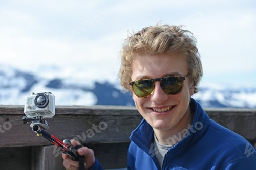 Preview: Teenage Boy Using Camcorder On Skiing Holiday, Tirol, Austria, Europe