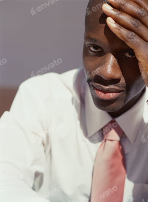 Preview: African American Businessman Resting Head On Hand