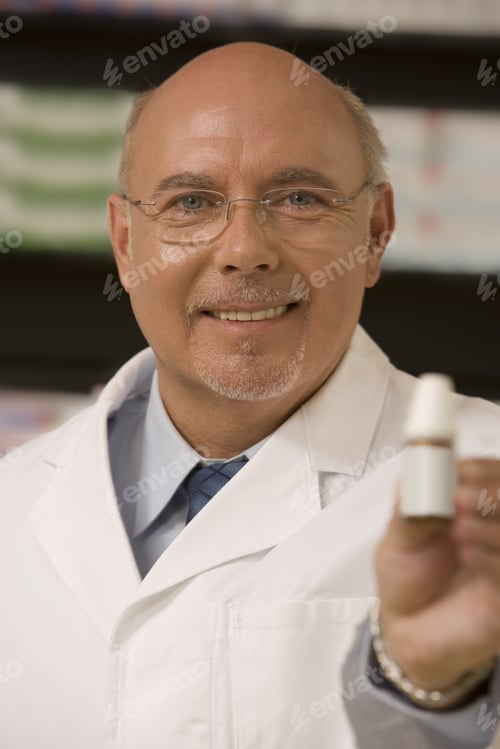 Preview: Male Pharmacist Smiling And Holding Medication