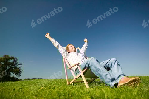 Preview: Man Sitting In Deckchair In Field