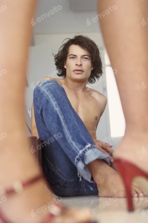 Preview: Woman Wearing Red High Heels, Man Sitting In The Background