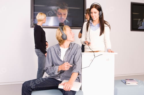 Preview: Students Using Headphones In Library