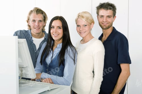 Preview: Four Students Standing At Library Computer, Smiling, Portrait