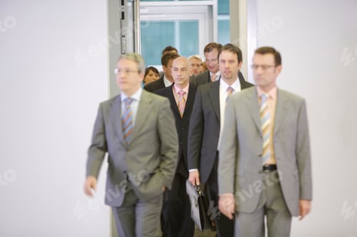 Preview: Businesspeople Walking Out Of Doorway