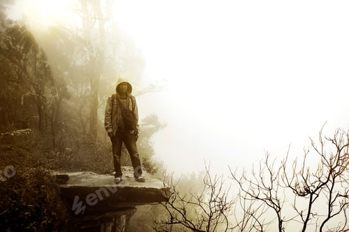 Preview: Alone Man Standing On The Rock With Fog In Nature Soft Blur Background