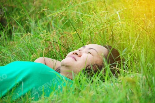 Preview: Beautiful Healthy Young Woman Lying And Relaxing On The Green Grass, Subject Is Blurred