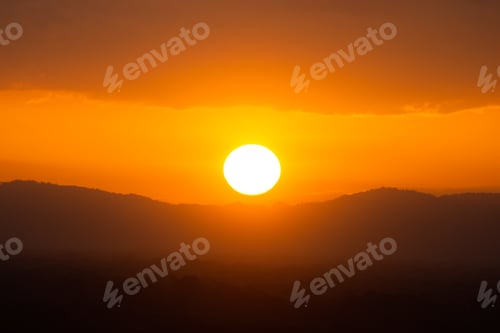 Preview: Silhouette Mountain And Sunset Sky With Sun Under The Clouds