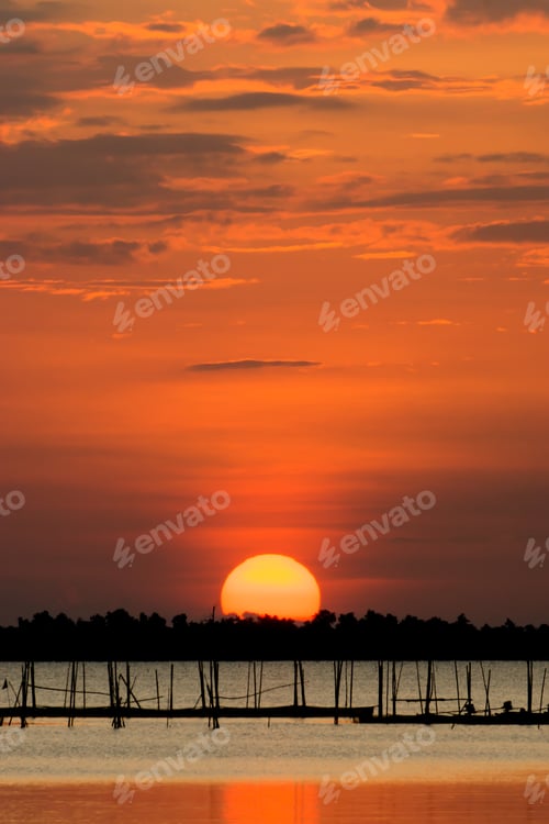 Preview: Sunset Reflecting On The Water At The Lake With Silhouette Of Fish Farm In The Lake.