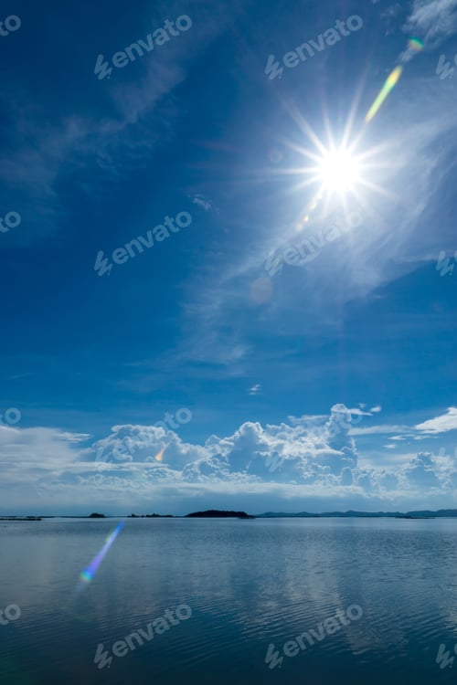 Preview: Blue Sky With Sun Flare And Cloud Over The Lake.
