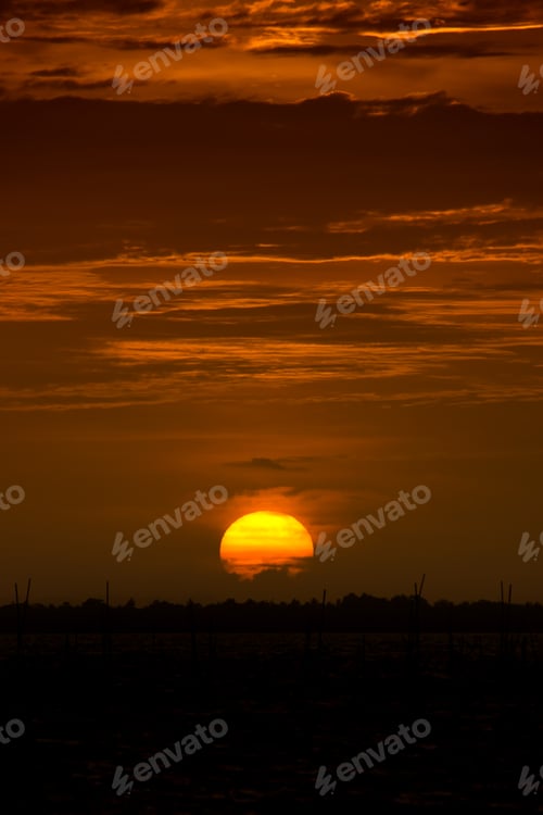Preview: Silhouette Ground With Big Sunset Sky And Dark Orange Clouds