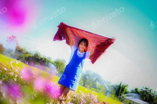 Preview: Asian Young Woman Feeling Fresh In Flower Garden.