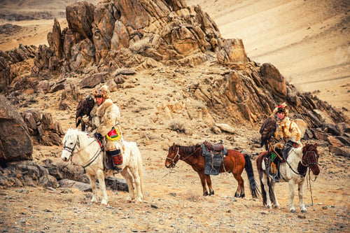 Preview: Kazakh Eagle Hunter In Traditionally Trained Golden Eagles Riding Horse In A Desert Mountain Golden