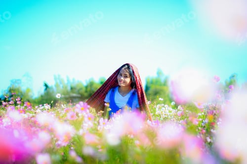 Preview: Asian Young Woman Feeling Fresh In Flower Garden.