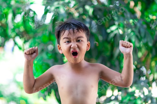 Preview: Portrait Little Asian Boy Showing His Muscles