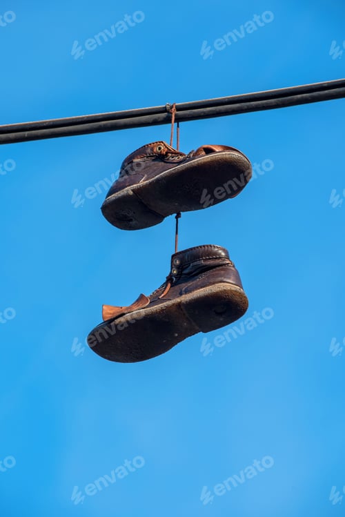 Preview: Shoes Hanging On A Wire With Blue Sky