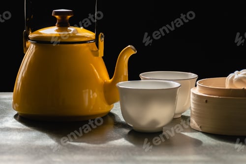 Preview: Two White Cups And Yellow Pot Of Tea Or Coffee, Steamed Buns In Wooden Basket, Morning Tea On Black