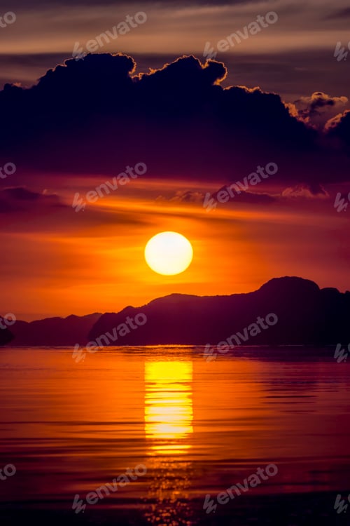Preview: Sunset Sky With Dark Cloud And Silhouette Mountain Mirror On The Water At The Lake In Golden Time.