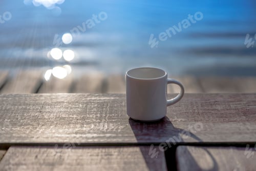 Preview: White Coffee Mug On Wooden With Blur Background In The Morning.