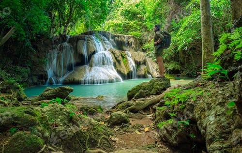 Preview: The Young Traveler Relaxes In The Green Forest And Enjoy The Scenery In The Waterfall