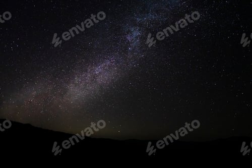 Preview: The Night Sky With Milky Way And Stardust Above The Black Mountain.