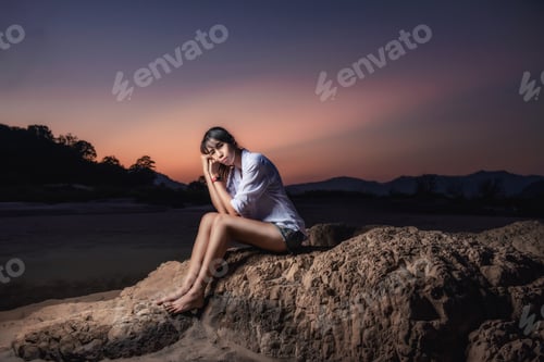 Preview: Woman Traveler Sitting On A Rock In Sea Shore Of The Thailand Beach
