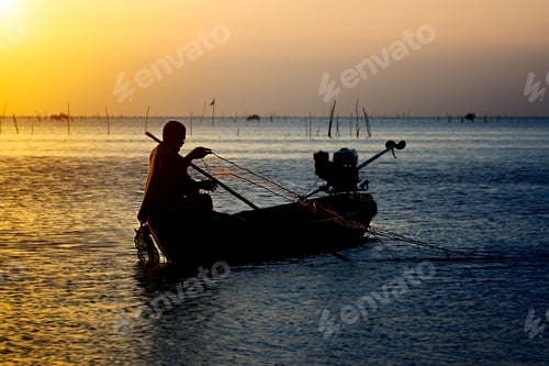 Preview: Silhouette Fisherman And Sunset Sky On The Lake.