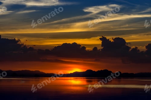 Preview: Sunset Sky With Cloud And Silhouette Mountain At The Lake In Golden Time.
