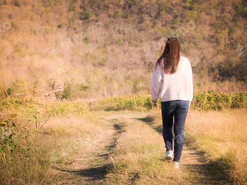 Preview: Backside From Young Long Hair Woman With Winter Cloth Walk And Chill Out At Side Of Meadow On Windy