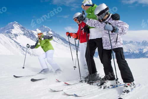Preview: A Cool Adventurous Family Of Skiers Skiing Down On A Snowy Slope From Top Of The Mountain In A Low