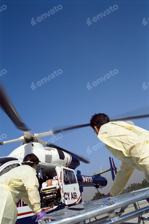 Preview: A Vertical View Of Paramedics Rushing Patient To Emergency Airlift Helicopter By Using Gurney