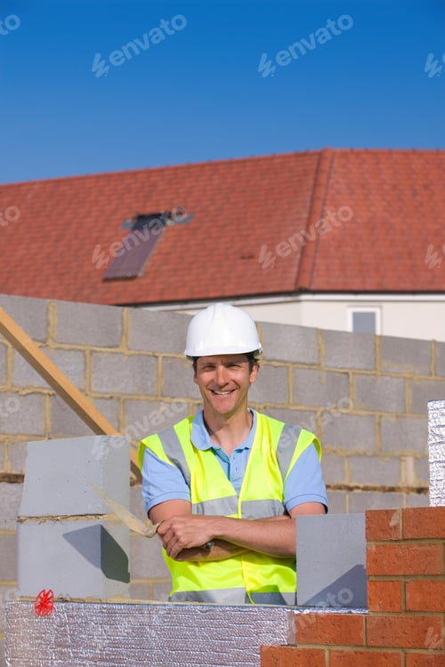 Preview: A Portrait Of A Smiling Bricklayer In Reflective Vest And A Helmet Holding A Trowel While Standing