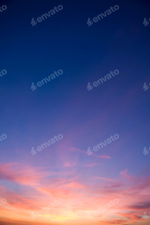 Preview: A Portrait Shot Of Beautiful Pink Clouds In A Blue Peaceful Sky During Sunset.