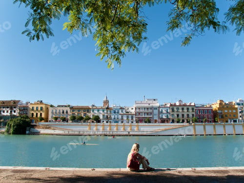 Preview: Tourist Sitting On Waterfront In Seville, Spain