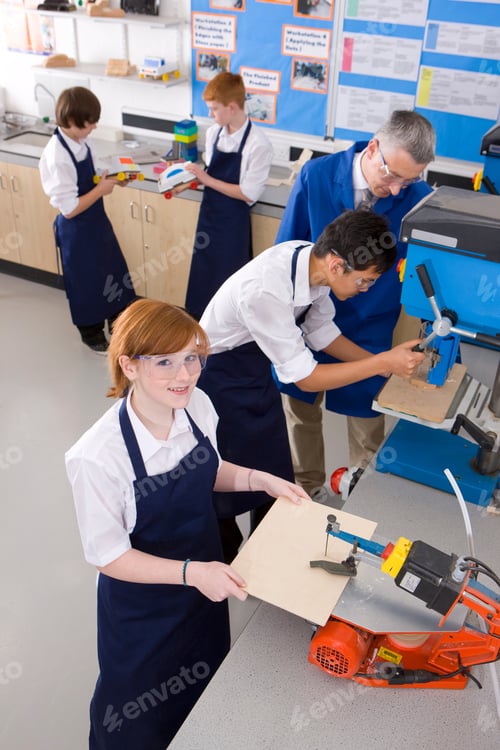 Preview: A High Angle Vertical Shot Of A Young Girl Looking Up And Smiling While Teacher Watching Other